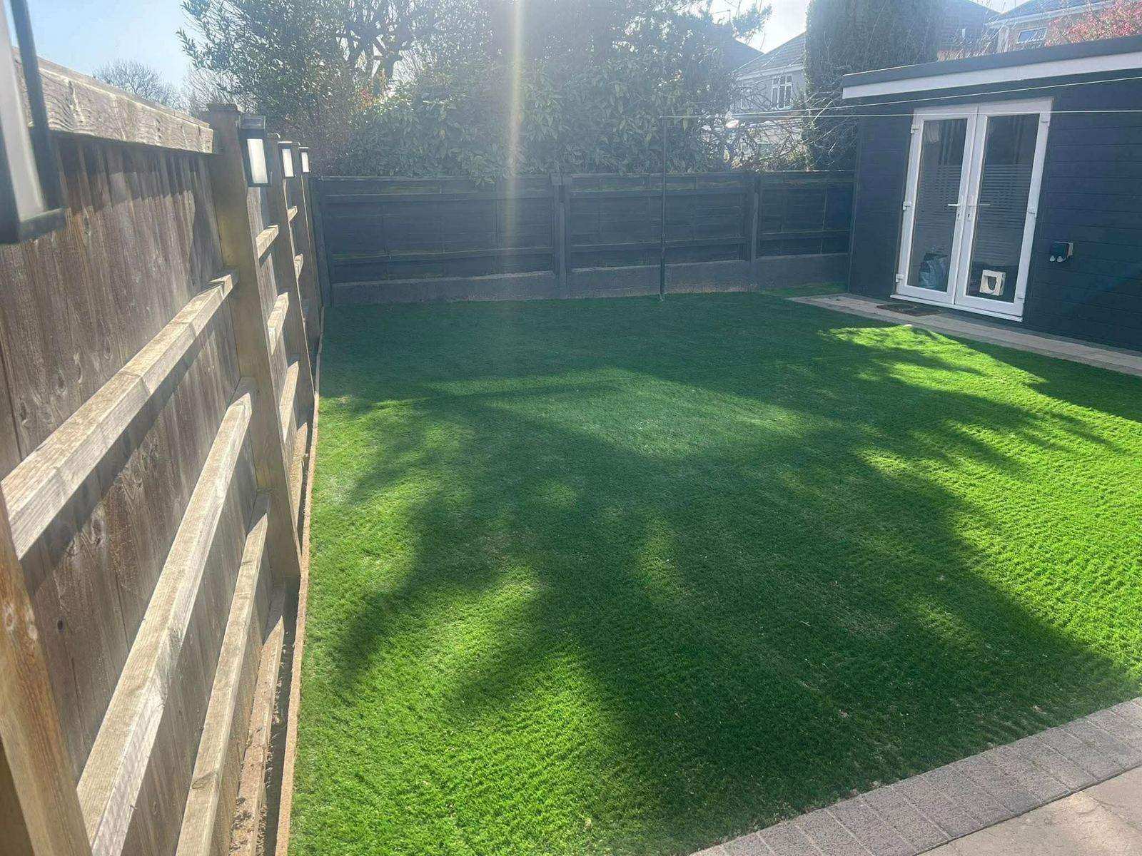 Artificial grass lawn with new fencing